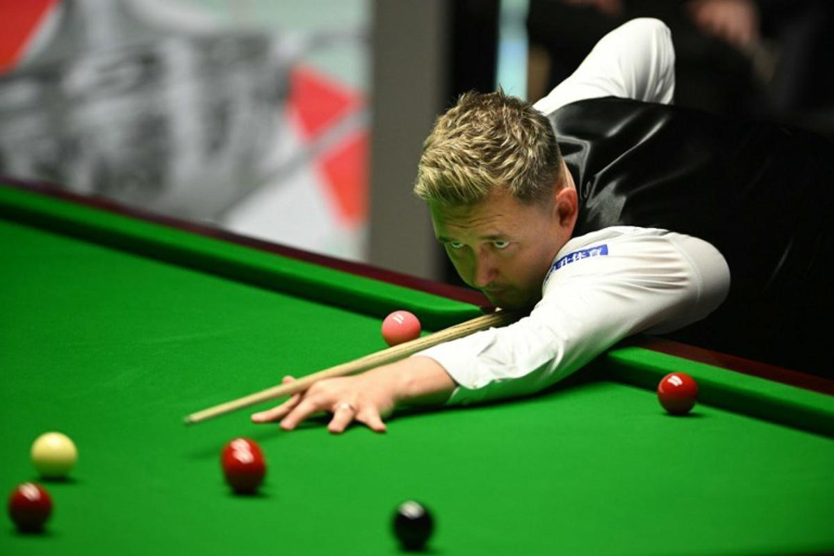 England's Kyren Wilson plays a shot on day two of his World Championship Snooker final against Wales' Jak Jones during the evening session at The Crucible in Sheffield, northern England on May 6, 2024. Oli SCARFF / AFP