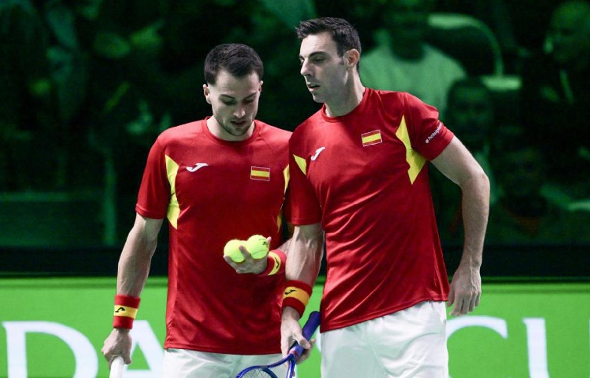 Spain's Pedro Martinez Portero (R) stands next to Spain's Marcel Granollers-Pujol preparing to serve the ball during their 2025 Davis Cup semi-final doubles tennis match against Germany at the Super Tennis Arena in Bologna, northen Italy, on November 22, 2025. Tiziana FABI / AFP