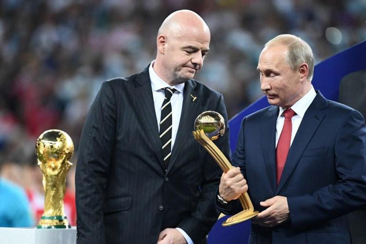 Russian President Vladimir Putin holds the adidas Golden Ball prize beside FIFA president Gianni Infantino (L) during the trophy ceremony at the end of the Russia 2018 World Cup final football match between France and Croatia at the Luzhniki Stadium in Moscow on July 15, 2018. FRANCK FIFE / AFP RESTRICTED TO EDITORIAL USE - NO MOBILE PUSH ALERTS/DOWNLOADS