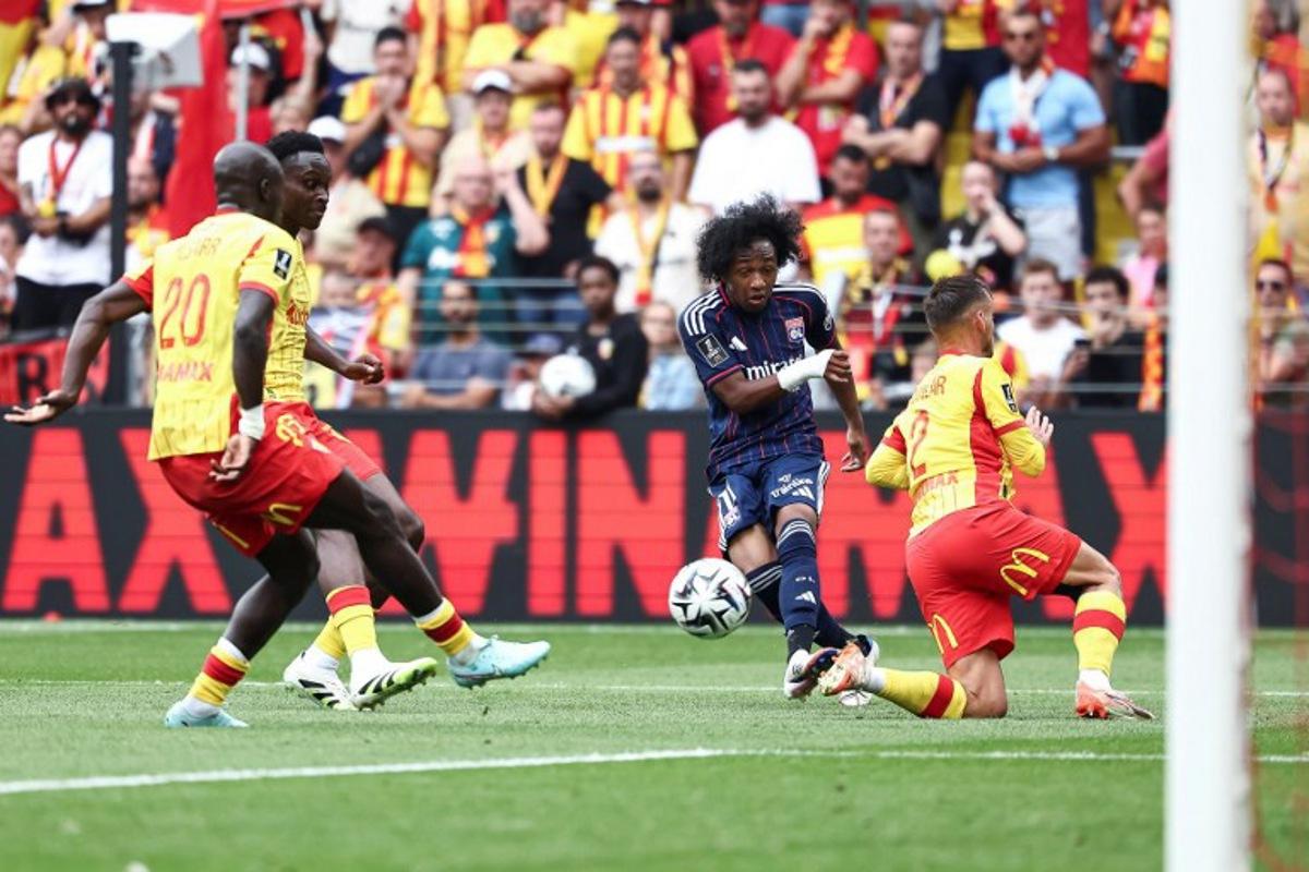 Lyon's Belgian forward #11 Malick Fofana (C) kicks the ball as he tries to score during the French L1 football match between RC Lens and Olympique Lyonnais (OL) at Stade Bollaert-Delelis in Lens, northern France on August 16, 2025. Sameer Al-DOUMY / AFP