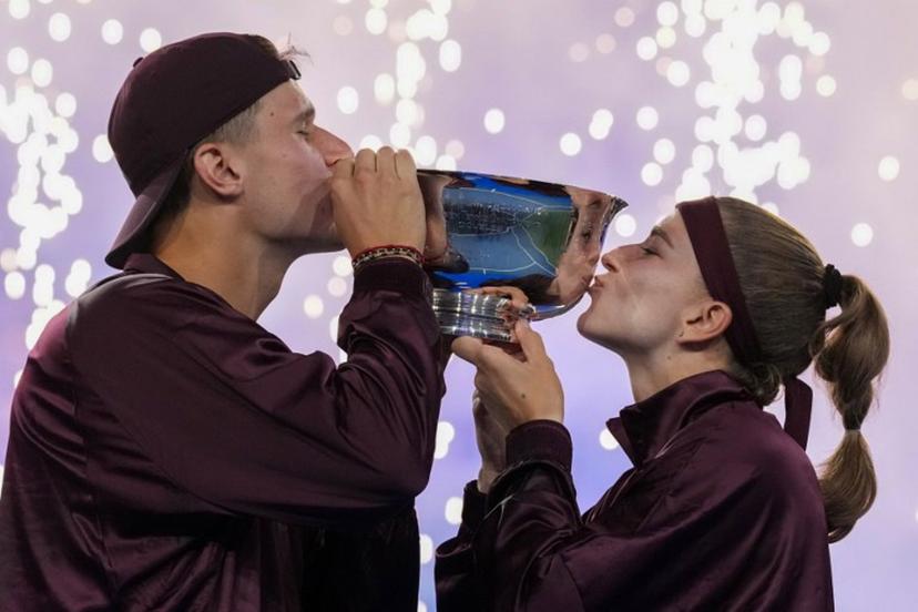 Czech Republic's Jakub Mensik and Czech Republic's Karolina Muchova kiss the trophy while celebrating the victory over Switzerland's Belinda Bencic and Italy's Flavio Cobolli in the mixed doubles final tennis match of the 2026 US Open tennis tournament at the USTA Billie Jean King National Tennis Center in New York on August 26, 2026. TIMOTHY A. CLARY / AFP
