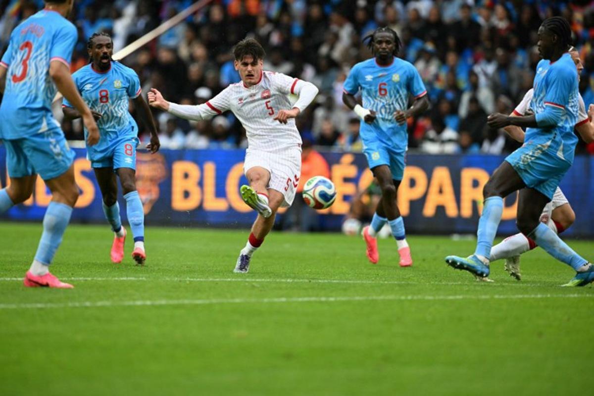 Denmark's defender #05 Joakim Maehle (C) shoots the ball during the international friendly football match between Denmark and DR Congo ahead of the 2026 FIFA World Cup football tournament at the Stade Maurice Dufrasne in Liege on June 3, 2026. NICOLAS TUCAT / AFP