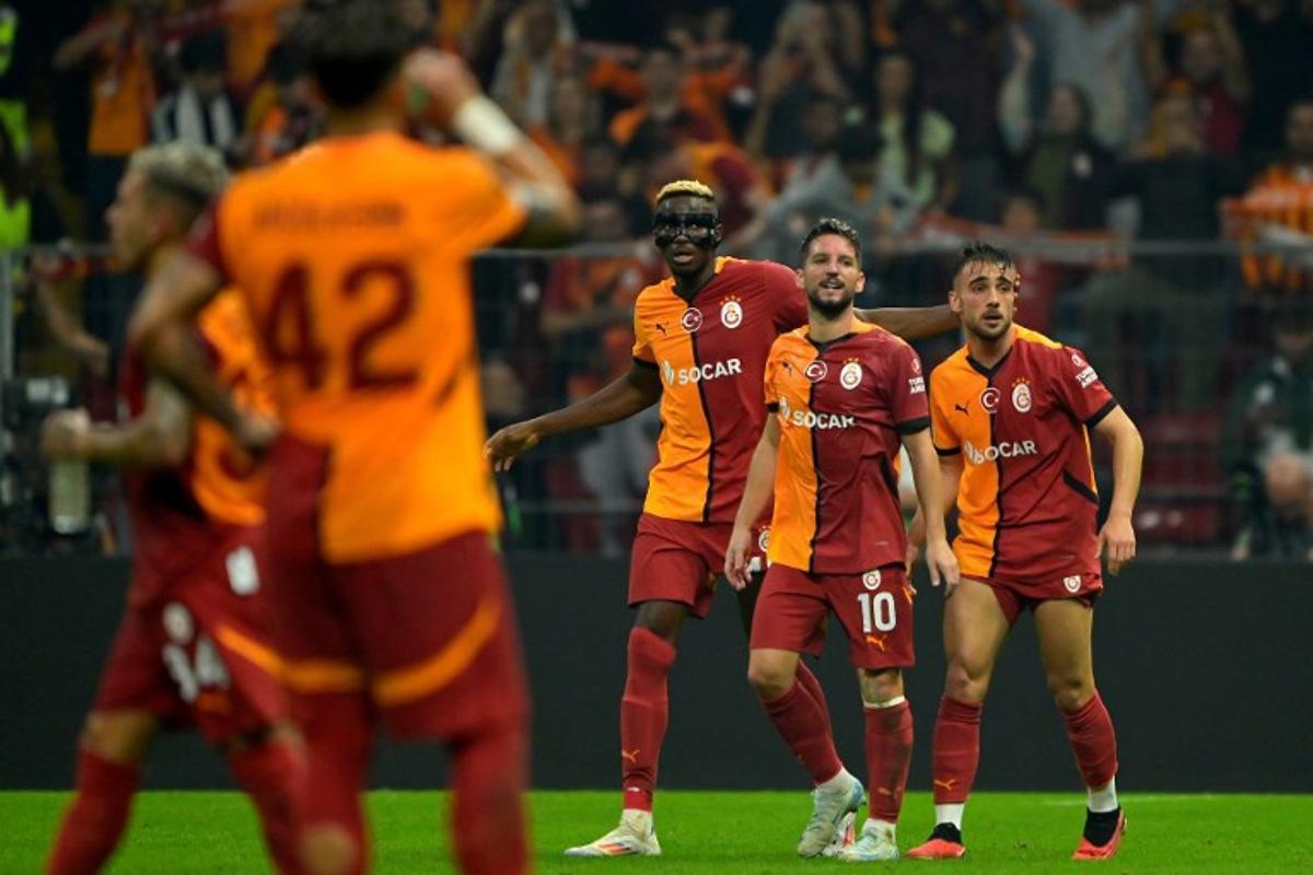 Galatasaray's Turkish forward #11 Yunus Akgun (R) celebrates scoring his team's second goal with Glatasaray's Belgian forward #10 Dries Mertens (2nd-R) and Galatasaray's Nigerian forward #45 Victor Osimhen (C) during the UEFA Europa League 1st round day 1 football match between Galatasaray SK and PAOK FC at the Ali Sami Yen Sports Complex in Sisli, near Istanbul, on September 25, 2024. Yasin AKGUL / AFP