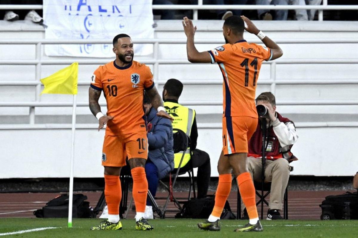 Netherlands' forward #10 Memphis Depay (L) celebrates scoring the opening goal with his teammate Netherlands' forward #11 Cody Gakpo during the 2026 FIFA World Cup Qualifying Group G football match between Finland and the Netherlands in Helsinki on June 7, 2025. Markku Ulander / LEHTIKUVA / AFP