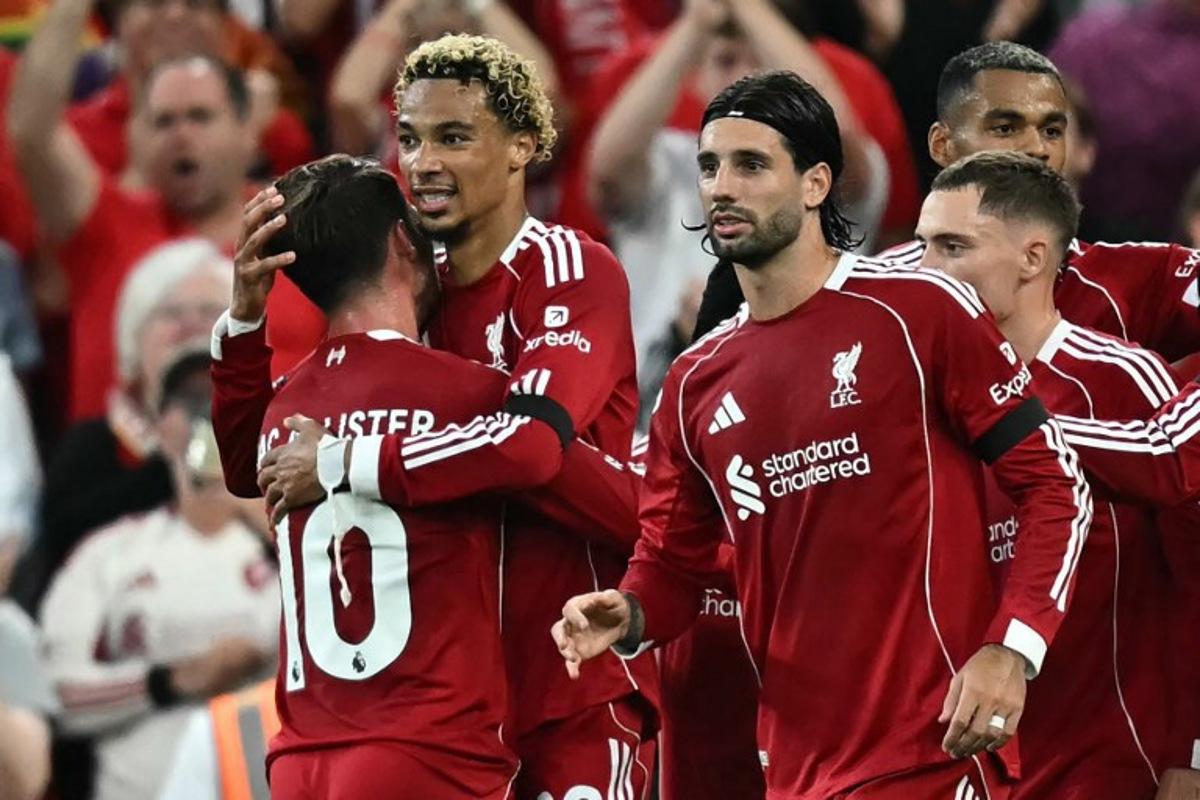 Liverpool's French striker #22 Hugo Ekitike (2L) celebrates with teammates after scoring the opening goal of the English Premier League football match between Liverpool and Bournemouth at Anfield in Liverpool, north west England on August 15, 2025. Paul ELLIS / AFP