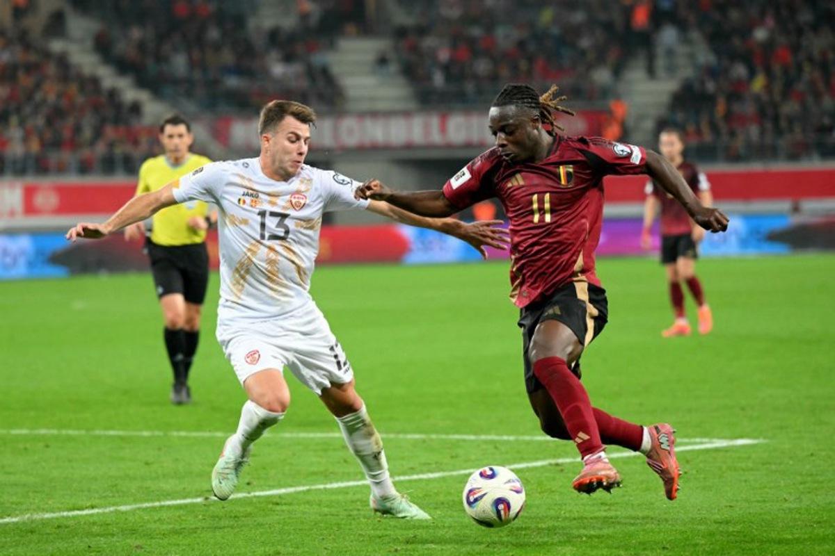 North Macedonia's defender #13 Stefan Despotovski (L) fights for the ball with Belgium's forward #11 Jeremy Doku during the FIFA World Cup 2026 Group J European qualification football match between Belgium and North Macedonia at the Planet Group Arena in Ghent, on October 10, 2025. NICOLAS TUCAT / AFP