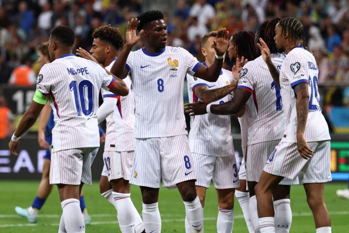 France's forward #11 Michael Olise celebrates with his team mates after scoring his team's first goal during the 2026 World Cup qualifiers Europe zone group D football match between Ukraine and France, on September 5, 2025 in Wroclaw, Poland. FRANCK FIFE / AFP