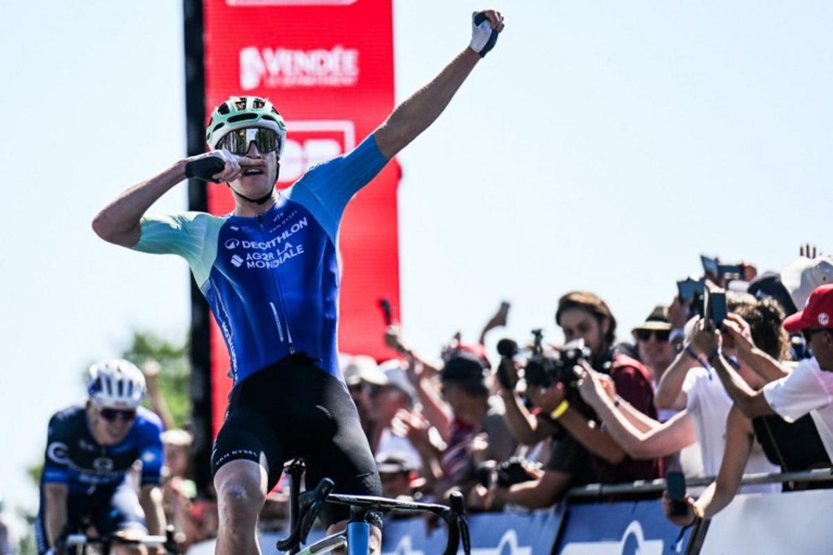 Decathlon-AG2R La Mondiale's French rider Dorian Godon gestures as he crosses the finish line to win the men's Elite race of the French National Road Cycling championships, in Les Herbiers, western France, on June 29, 2025. Sebastien Salom-Gomis / AFP