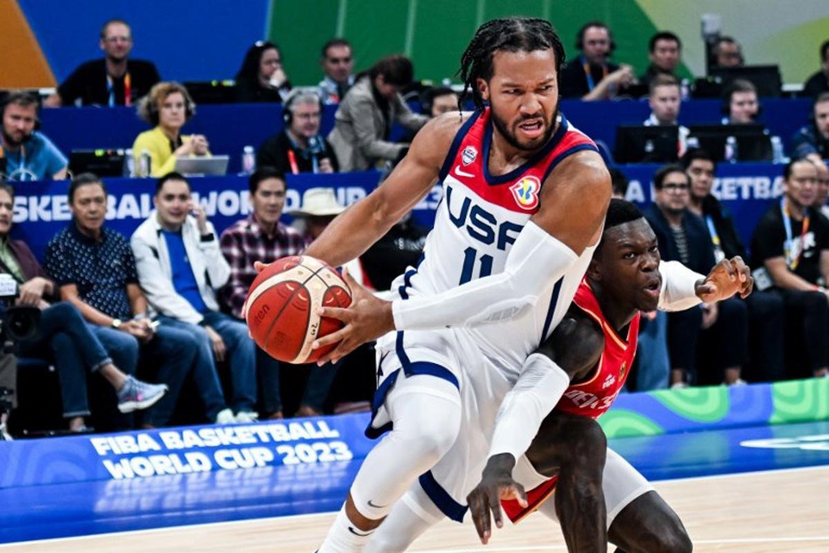 USA's Jalen Brunson (L) blows past Germany's Dennis Schroder during the FIBA Basketball World Cup semi-final match between USA and Germany in Manila on September 8, 2023. SHERWIN VARDELEON / AFP