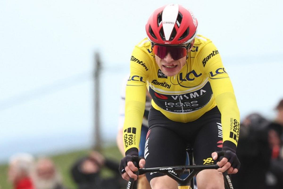 Team Visma-Lease a Bike's Danish rider Jonas Vingegaard wearing the overall leader's yellow jersey reacts as he crosses the finish line of the 5th stage of the Paris-Nice cycling race, 203,3 km between Saint-Just-en-Chevalet and La Côte-Saint-André, on March 13, 2025. Anne-Christine POUJOULAT / AFP