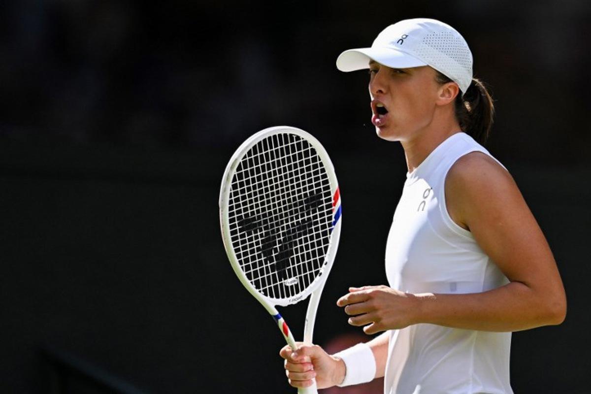 Poland's Iga Swiatek celebrates winning a point against US player Amanda Anisimova during their women's singles final tennis match on the thirteenth day of the 2025 Wimbledon Championships at The All England Lawn Tennis and Croquet Club in Wimbledon, southwest London, on July 12, 2025. Kirill KUDRYAVTSEV / AFP