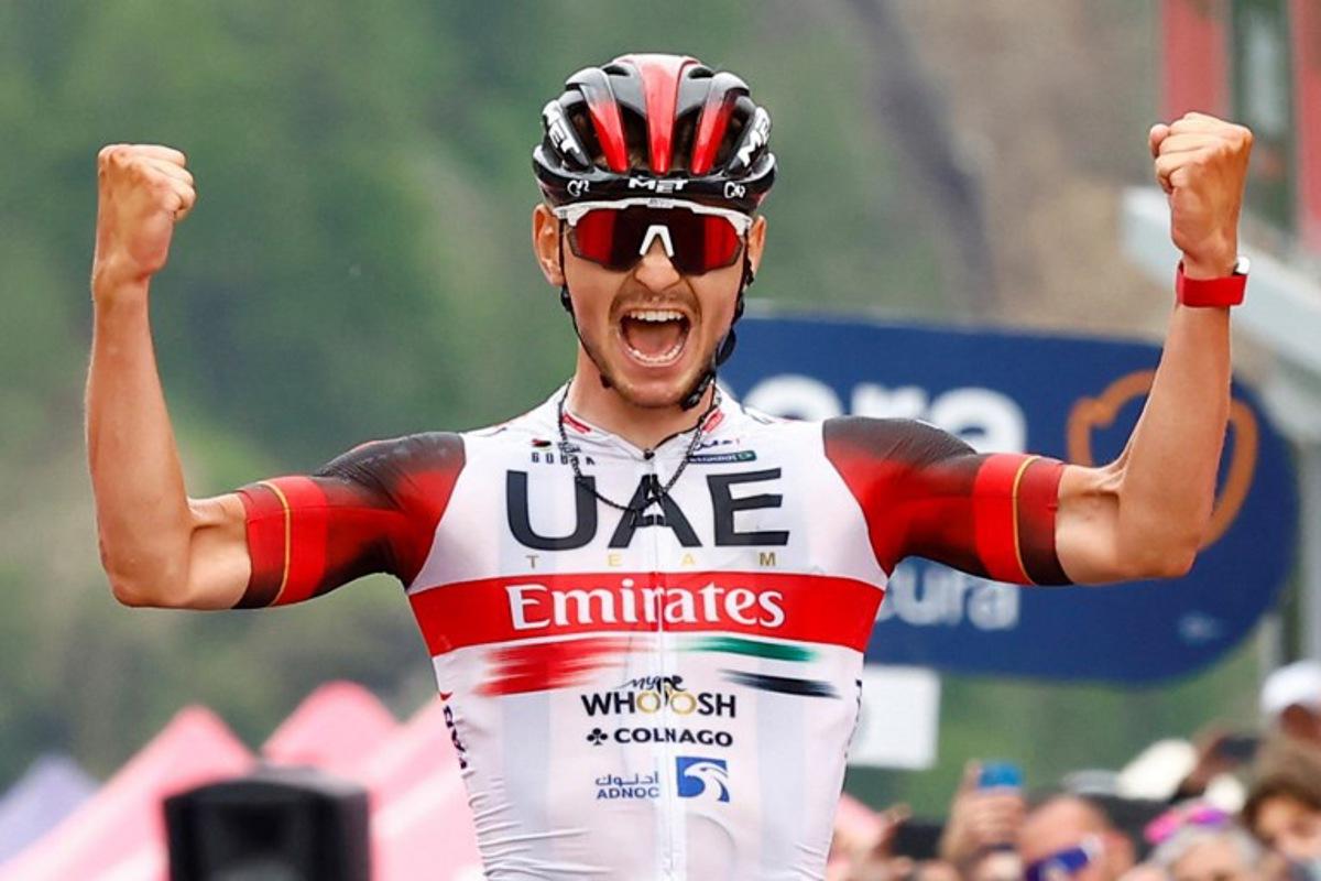 Team UAE Emirates' Italian rider Alessandro Covi celebrates as he crosses the finish line to win the 20th stage of the Giro d'Italia 2022 cycling race, 168 kilometers from Belluno to Marmolada (Passo Fedaia) on May 28, 2022. Roberto Bettini / AFP