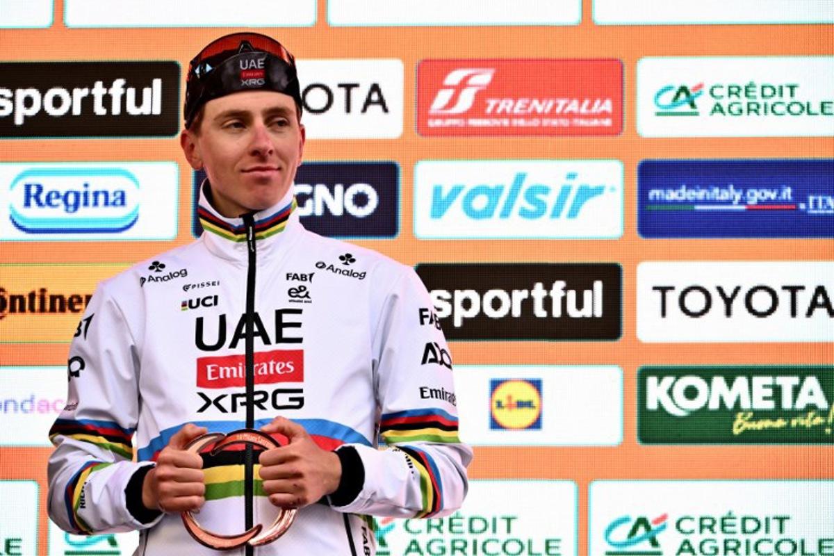 Team UAE's Slovenian rider Tadej Pogacar, third, celebrates during the podium ceremony of the Milan - Sanremo one-day classic cycling race, on March 22, 2025. Dutch Mathieu Van Der Poel of team Alpecin-Deceuninck won the race ahead of Team Ineos' Italian rider Filippo Ganna and Team UAE's Slovenian rider Tadej Pogacar, third. Marco BERTORELLO / AFP