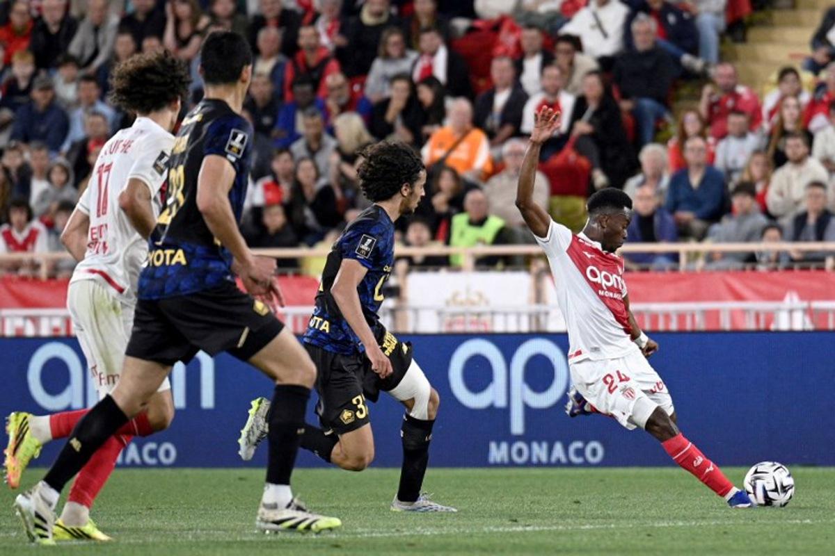 Monaco's Ivorian forward #24 Simon Adingra (R) kicks the ball in an attempt to score during the French L1 football match between Monaco (ASM) and Lille (LOSC) at the Louis II Stadium (Stade Louis II) in the Principality of Monaco on May 10, 2026. Frederic DIDES / AFP