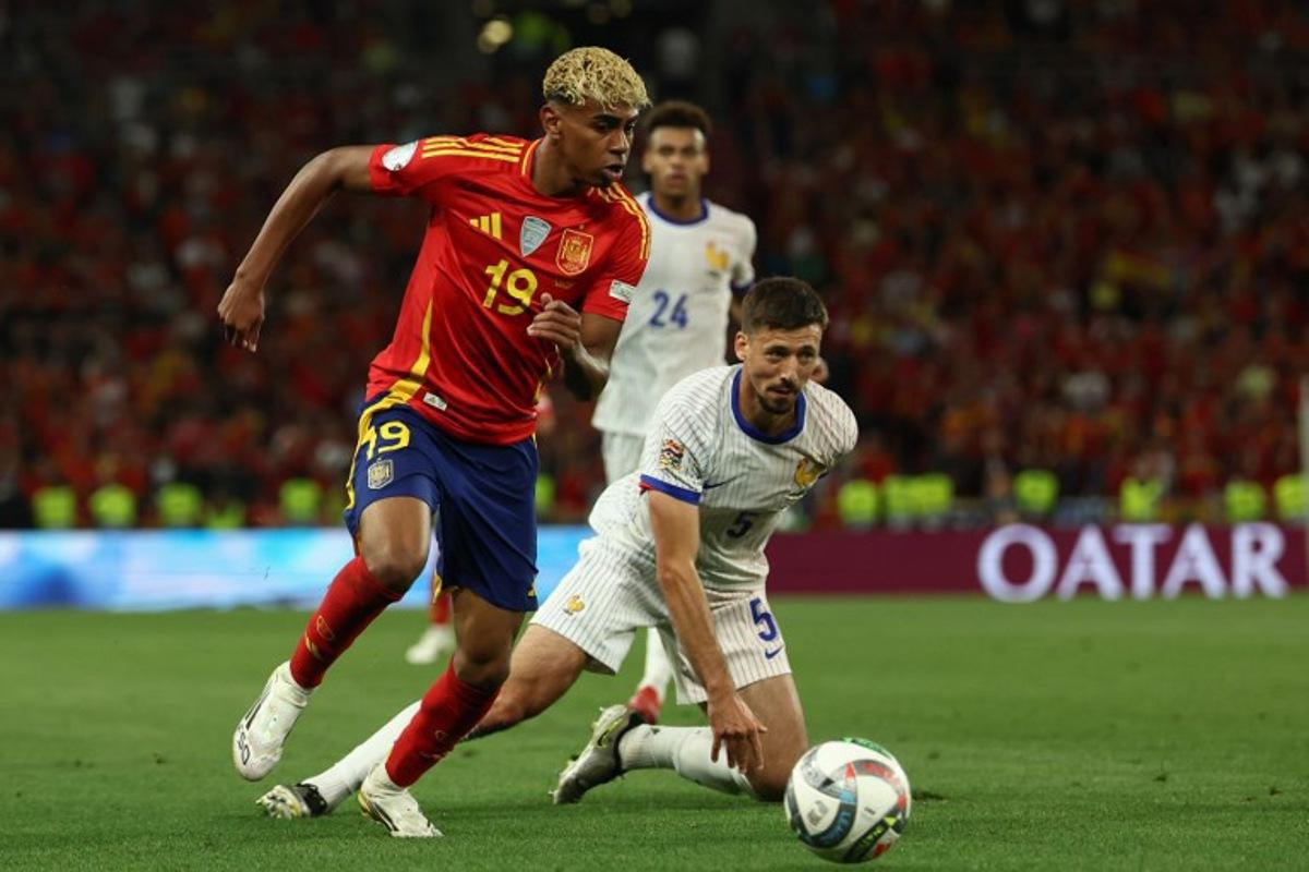 Spain's forward #19 Lamine Yamal (L) and France's defender #05 Clement Lenglet vie for the ball during the UEFA Nations League semi-final football match between Spain and France in Stuttgart, southwestern Germany, on June 5, 2025. FRANCK FIFE / AFP