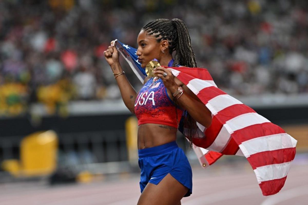 US' athlete Tara Davis-Woodhall celebrates with her gold medal after winning the women's long jump final during the World Athletics Championships in Tokyo on September 14, 2025. Andrej ISAKOVIC / AFP