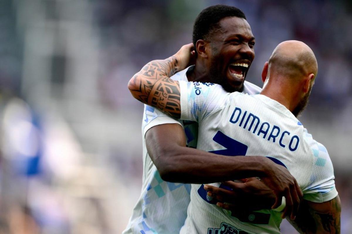 Inter Milan's French forward #9 Marcus Thuram (L) celebrates with Inter Milan's Italian defender #32 Federico Dimarco (R) after scoring Inter's first goal during the Italian Serie A football match between Torino and Inter Milan at the Olympic Stadium Grande Torino in Turin on April 26, 2026. MARCO BERTORELLO / AFP