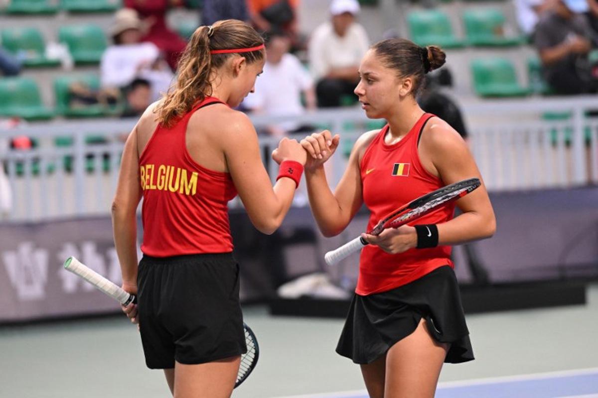 Belgium's Hanne Vandewinkel (L) and Sofia Costoulas (R) speak during their women's doubles match against China's Guo Hanyu and Jiang Xinyu at the Billie Jean King Cup tennis play-offs at the Guangzhou Nansha International Tennis Center in Guangzhou, in south China's Guangdong province on November 17, 2024. STR / AFP
