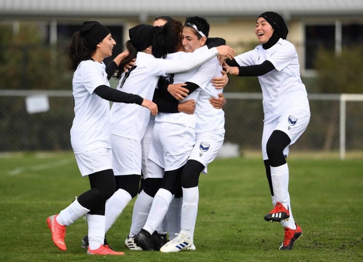 Melbourne Victory Afghan women's team player Manozh (2nd R) and teammates celebrate a goal which was disallowed during their first match in a local league against ETA Buffalo SC in Melbourne on April 24, 2022. Players from Afghanistan's national women's football team competed in a local league match in Australia on April 24 for the first time since fleeing the hardline Islamist Taliban. William WEST / AFP