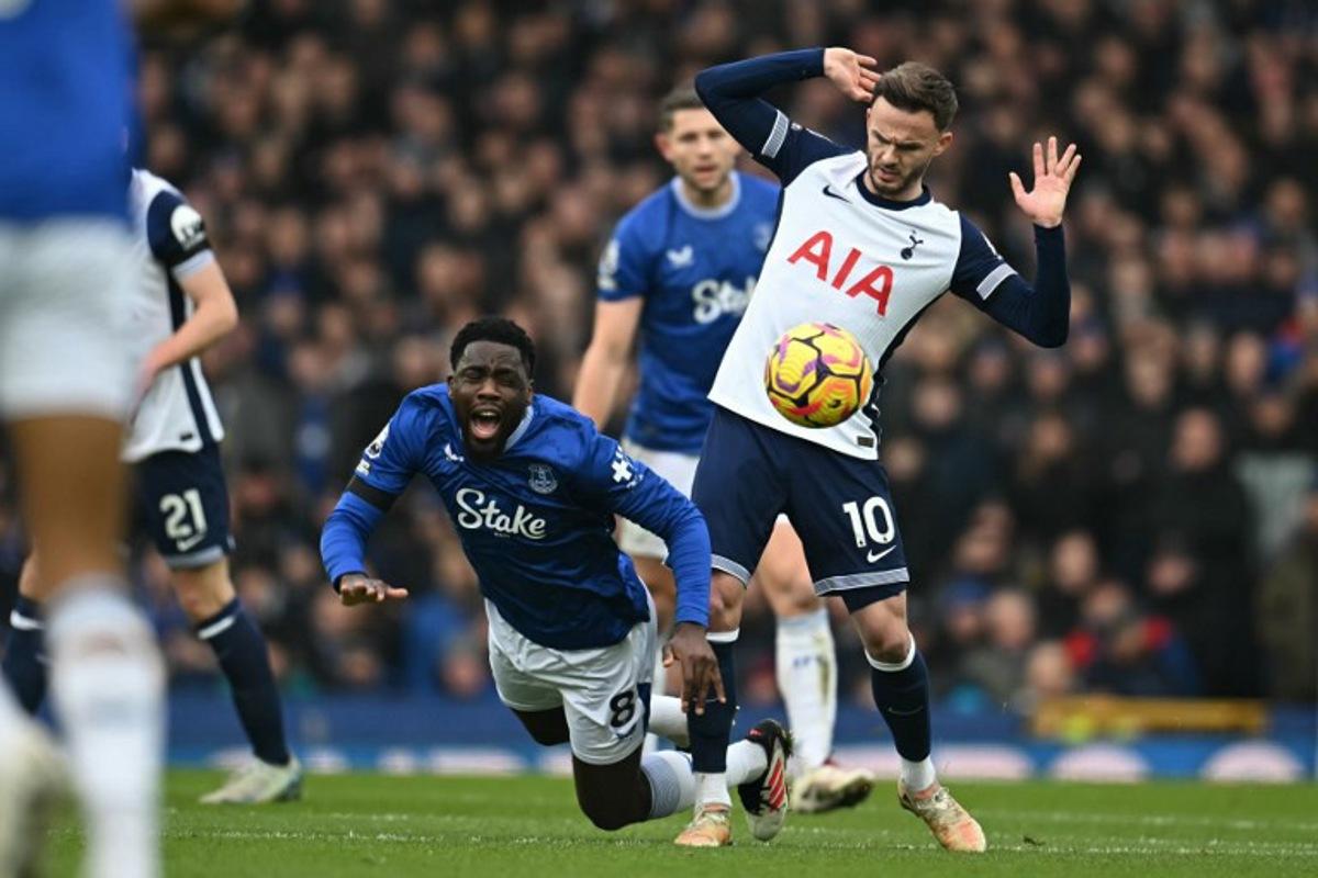 Everton's Belgian midfielder #08 Orel Mangala (L) vies with Tottenham Hotspur's English midfielder #10 James Maddison (R) during the English Premier League football match between Everton and Tottenham Hotspur at Goodison Park in Liverpool, north west England on January 19, 2025. Paul ELLIS / AFP