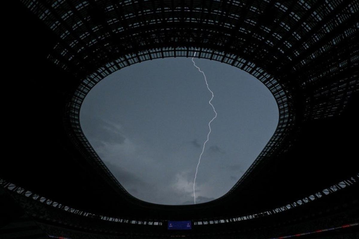 A bolt of lightning is seen in the sky above the National Stadium, ahead of the World Athletics Championships, in Tokyo on September 11, 2025. Kirill KUDRYAVTSEV / AFP