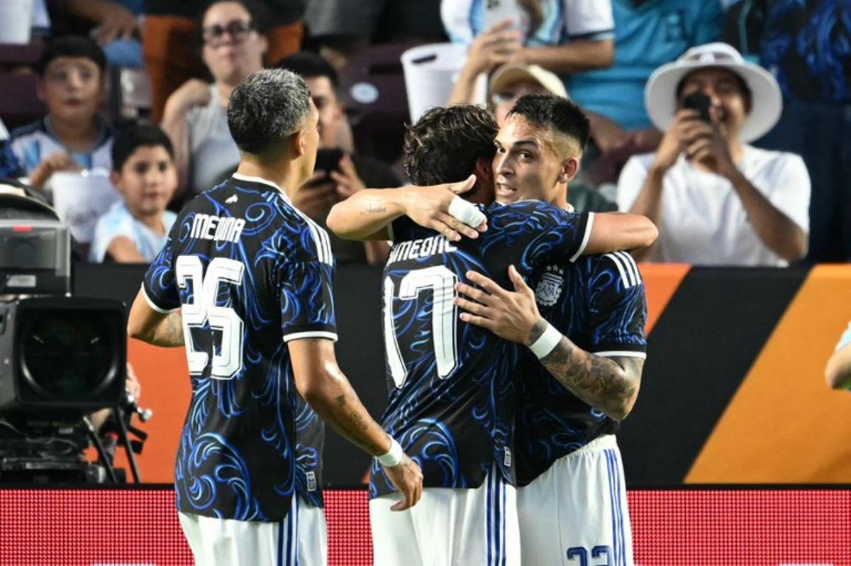Argentina's forward #22 Lautaro Martinez (R) and Argentina's defender #25 Facundo Medina celebrate with Argentina's forward #17 Giuliano Simeone after he scored a goal during the international friendly football match between Argentina and Honduras at Kyle Field in College Station, Texas on June 6, 2026. RONALDO SCHEMIDT / AFP