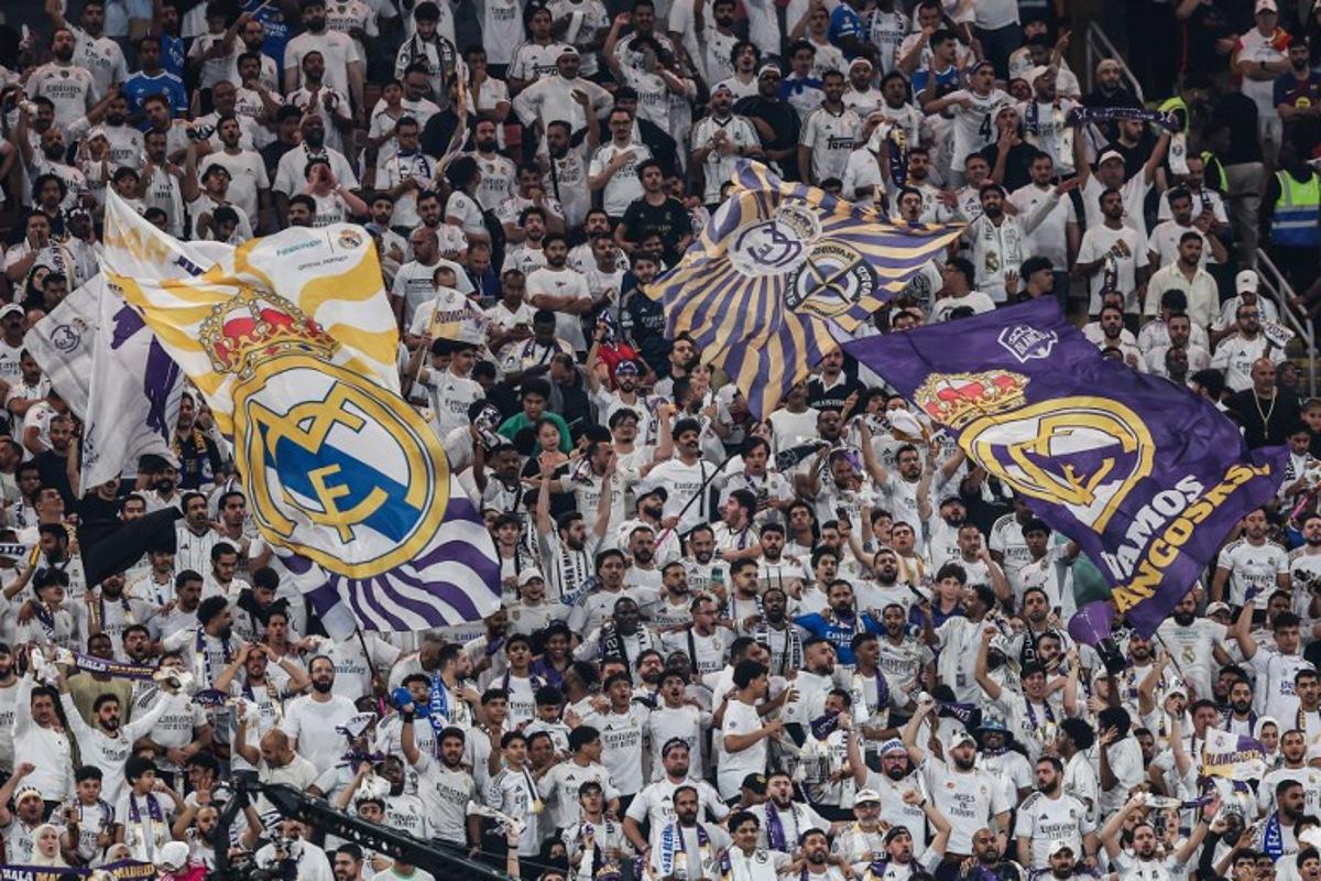 Real Madrid's fans cheer for their team during the Spanish Super Cup final football match between FC Barcelona and Real Madrid at the King Abdullah Stadium in Jeddah on January 11, 2026. Haitham AL-SHUKAIRI / AFP