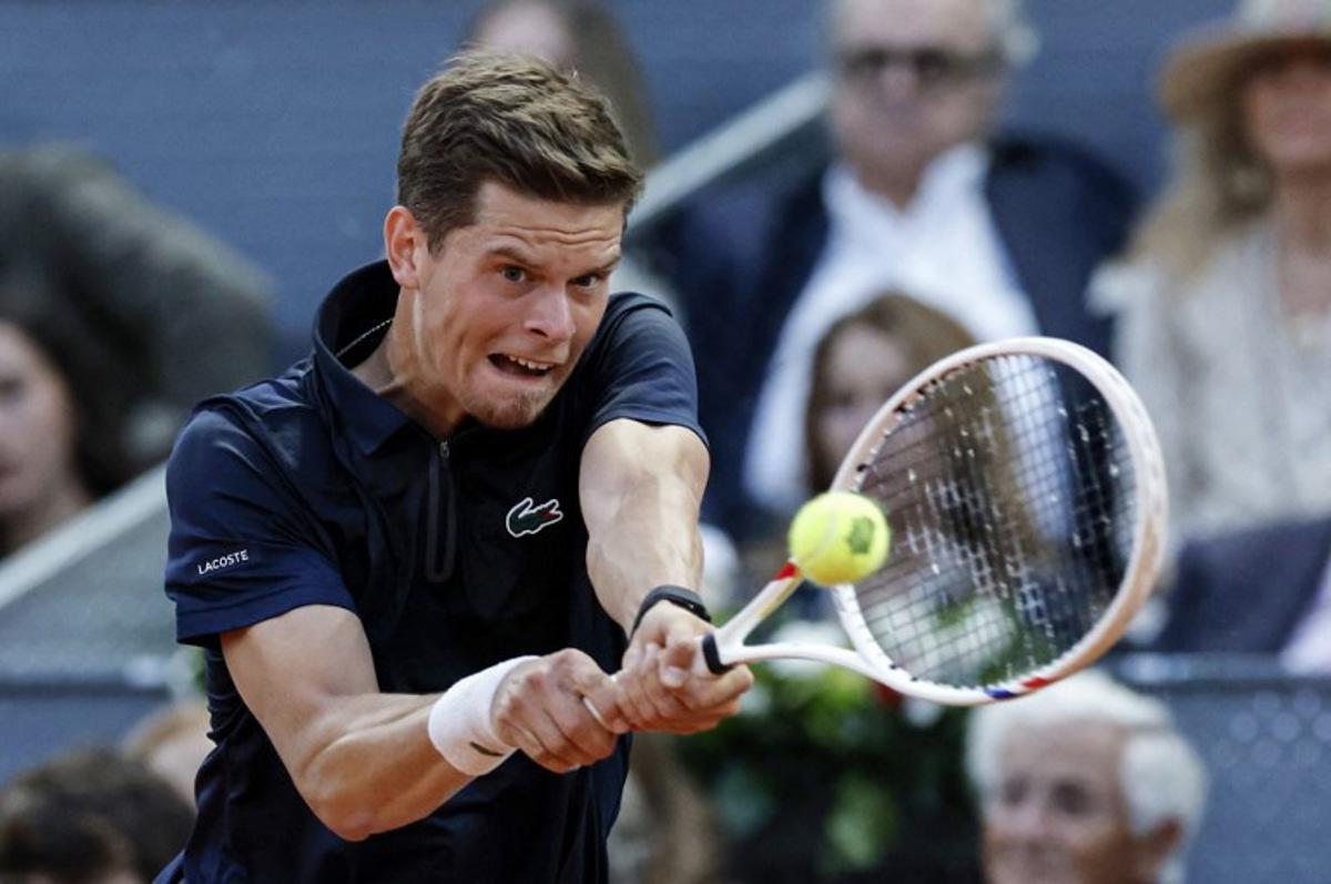 Belgium's Alexander Blockx returns the ball to Germany's Alexander Zverev during their 2026 ATP Tour Madrid Open tennis tournament semi-final singles match at the Caja Magica in Madrid, on May 1, 2026. OSCAR DEL POZO / AFP