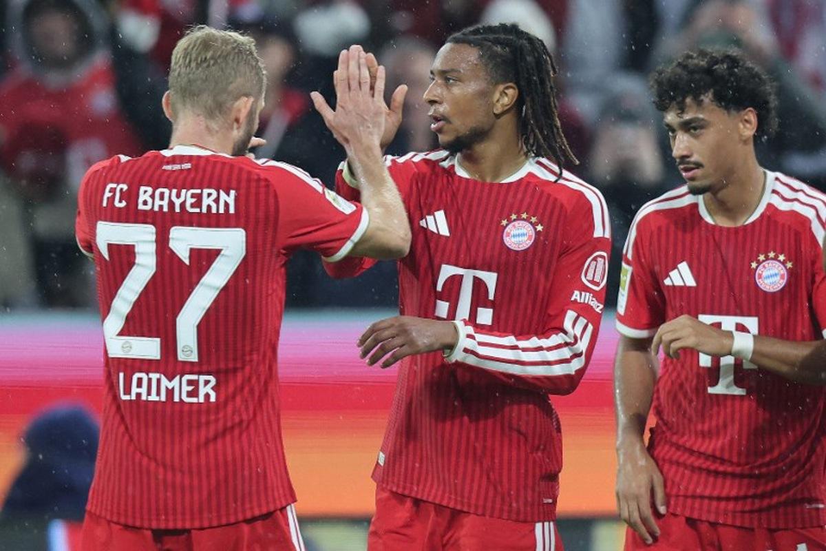 Bayern Munich's French midfielder #17 Michael Olise (C) celebrates scoring the 3-0 goal with his teammates including Bayern Munich's Austrian midfielder #27 Konrad Laimer (L) during the German first division Bundesliga football match between FC Bayern Munich and RB Leipzig in Munich, southern Germany, on October 17, 2026. Alexandra BEIER / AFP