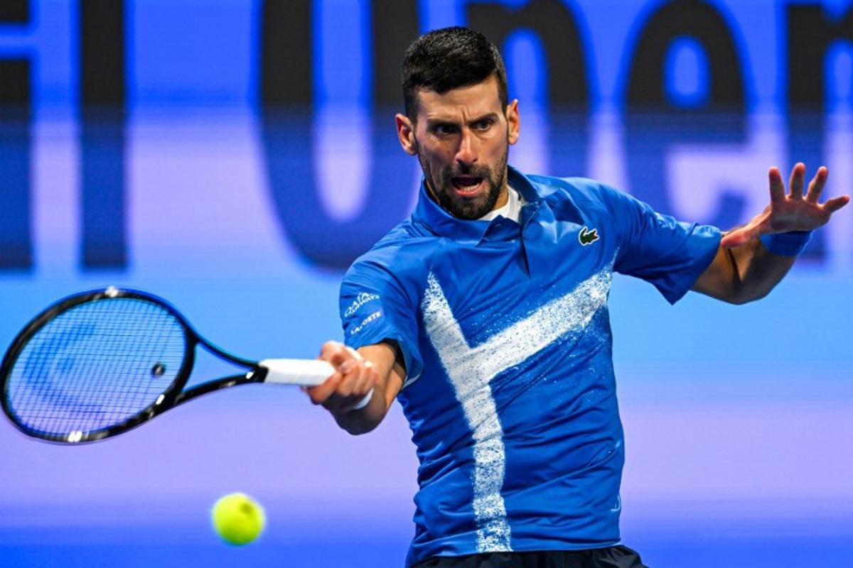 Serbia's Novak Djokovic hits a return to Italy's Matteo Berettini during their men's singles match at the ATP Qatar Open tennis tournament in Doha on February 18, 2025. Mahmud HAMS / AFP