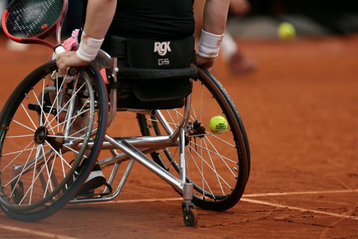 This photograph shows a ball stuck in the spokes of the wheelchair of Netherlands' Aniek Van Koot as she plays against Japan's Yui Kamiji during their women's wheelchair singles final match on day 14 of the French Open tennis tournament on Court Suzanne-Lenglen at the Roland-Garros Complex in Paris on June 7, 2025. Alain JOCARD / AFP