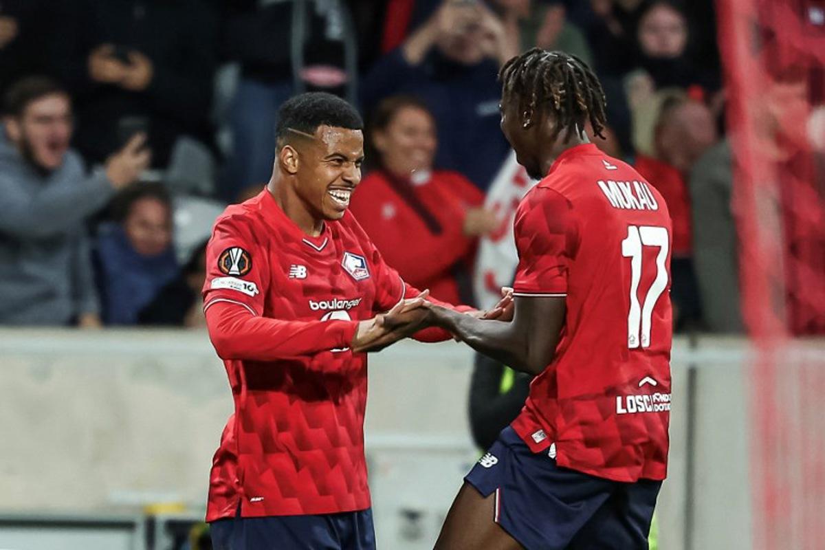 Lille's Moroccan forward #29 Hamza Igamane (L) celebrates with his teammate Lille's Congolese midfielder #17 Ngal'Ayel Mukau after scoring his team's opening goal during the UEFA Europa League 1st round day 1 football match between LOSC Lille and SK Brann at the Stade Pierre-Mauroy in Villeneuve-d'Ascq, northern France, on September 25, 2025. Sameer Al-DOUMY / AFP