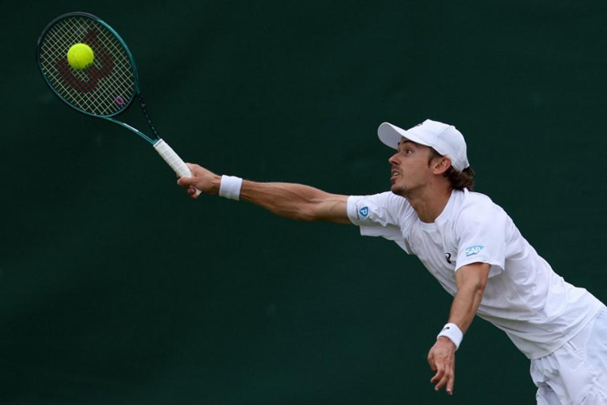 Australia's Alex De Minaur plays a forehand return to Denmark's August Holmgren during their men's singles third round tennis match on the sixth day of the 2025 Wimbledon Championships at The All England Lawn Tennis and Croquet Club in Wimbledon, southwest London, on July 5, 2025. Adrian Dennis / AFP