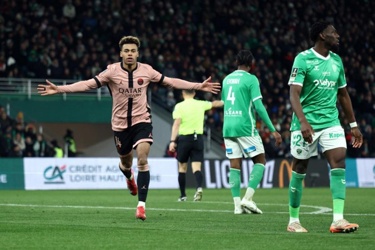 Paris Saint-Germain's French midfielder #14 Desire Doue celebrates scoring his team's third goal during the French L1 football match between AS Saint-Etienne and Paris Saint-Germain (PSG) at the Geoffroy-Guichard stadium in Saint-Etienne, central France on March 29, 2025. Alex MARTIN / AFP