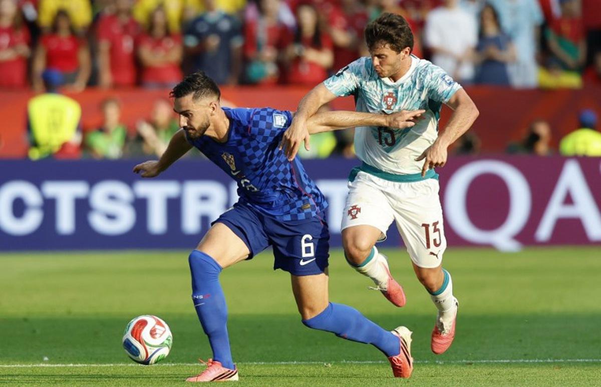 Croatia's defender #06 Josip Sutalo and Portugal's midfielder #15 Joao Neves fight for the ball during the 2026 World Cup round of 32 football match between Portugal and Croatia at the Toronto Stadium in Toronto on July 2, 2026. Kamil Krzaczynski / AFP