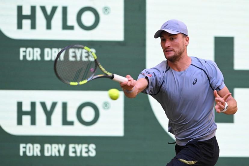 Belgium's Raphael Collignon returns the ball to Germany's Alexander Zverev during their men's singles quarter-final match of the Halle Open ATP tennis tournament in Halle, western Germany, on June 19, 2026. CARMEN JASPERSEN / AFP