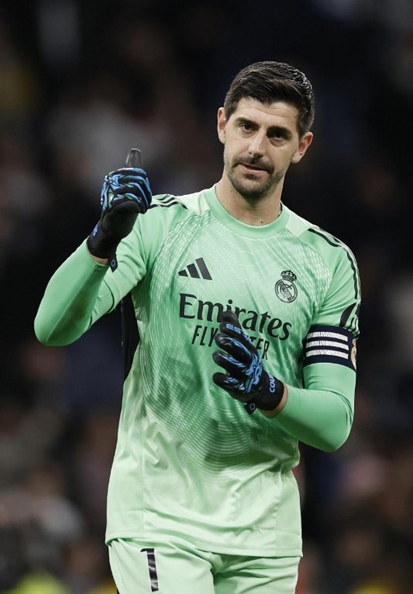Real Madrid's Belgian goalkeeper #01 Thibaut Courtois celebrates at the end of the Spanish league football match between Real Madrid CF and Sevilla FC at Santiago Bernabeu Stadium in Madrid on December 20, 2025. Oscar DEL POZO / AFP