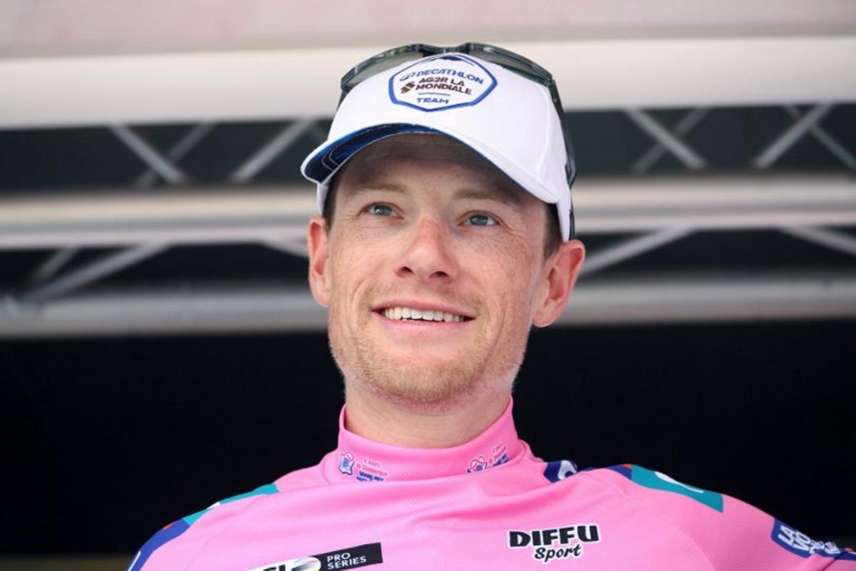 Decathlon AG2R La Mondiale's Irish rider Sam Bennett, wearing the overall leaders pink jersey, celebrates on the podium after the fifth stage of the "4 jours de Dunkerque" (Four days of Dunkirk) cycling race, 179 km from Arques to Cassel, in north France, on May 18, 2024. FRANCOIS LO PRESTI / AFP