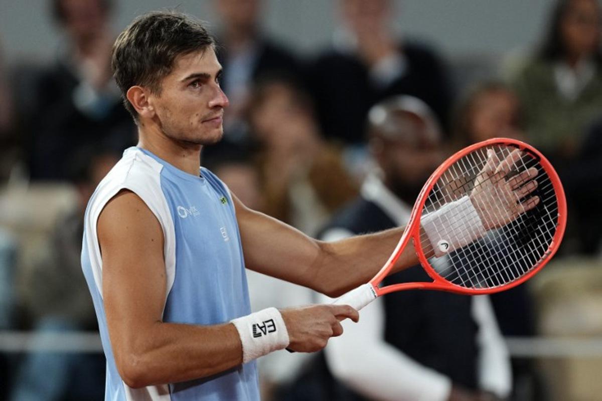 Italy's Matteo Arnaldi reacts to his victory after Italy's Matteo Berrettini withdrawn due to an injury at the end of their men's quarter final singles match on day 11 of the French Open tennis tournament on Court Philippe-Chatrier at the Roland-Garros Complex in Paris on June 3, 2026. Dimitar DILKOFF / AFP