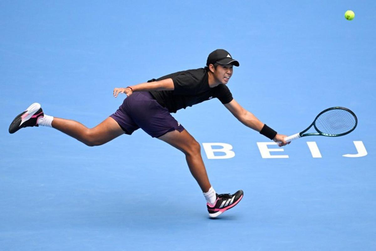 USA's Learner Tien hits a return to Italy's Jannik Sinner during their men's singles final match at the China Open tennis tournament in Beijing on October 1, 2025. WANG Zhao / AFP