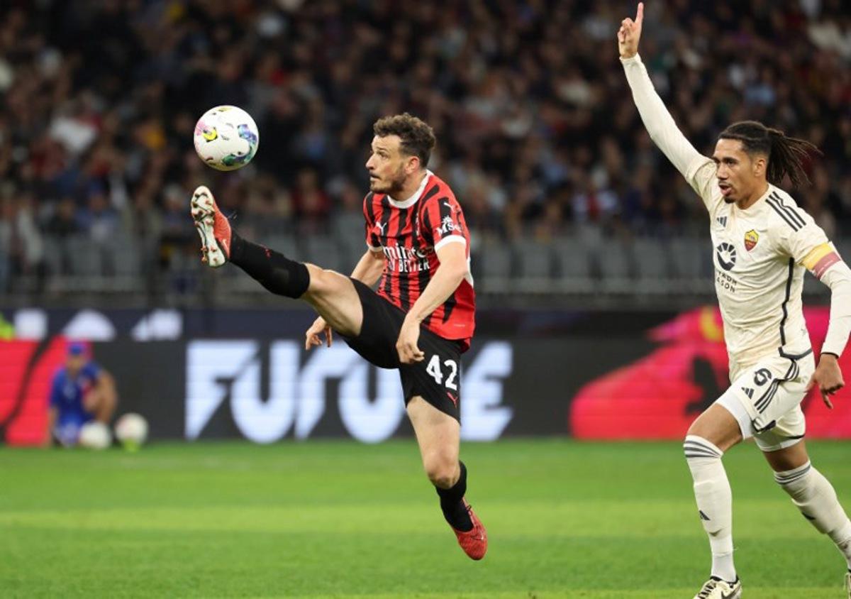 AC Milan's Alessandro Florenzi (L) kicks the ball as AS Roma's Chris Smalling gestures during a friendly match between AC Milan and AS Roma at the Perth Rectangular Stadium in Perth on May 31, 2024. COLIN MURTY / AFP