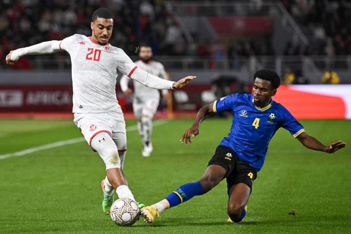 Tunisia's defender #20 Yan Valery and Tanzania's defender #04 Ibrahim Hamad vie during the Africa Cup of Nations (CAN) Group C football match between Tanzania and Tunisia at Rabat Olympic Stadium in Rabat on December 30, 2025. Paul ELLIS / AFP