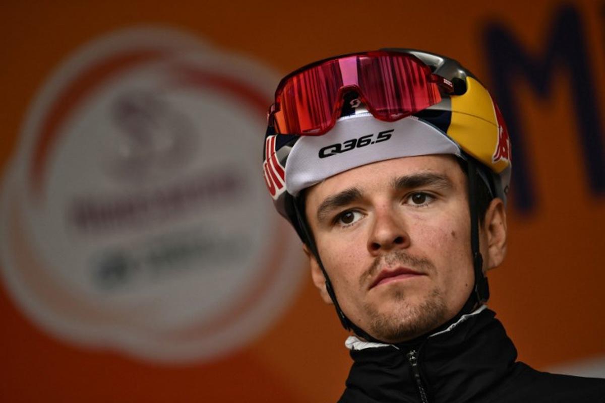 Team Q36.5's British rider Thomas Pidcock stands on stage before the start of the Milan - Sanremo one-day classic cycling race, in Pavia, near Milan, on March 22, 2025. Marco BERTORELLO / AFP
