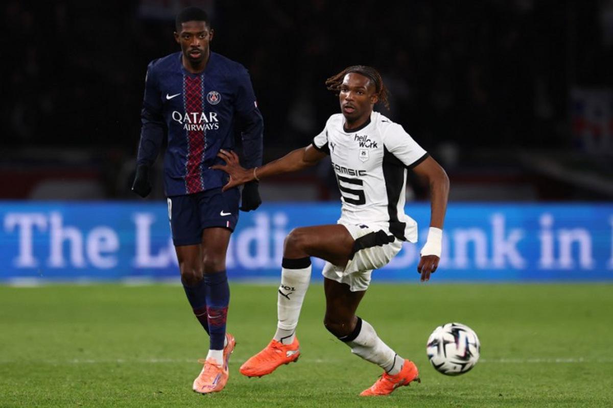 Paris Saint-Germain's French forward #10 Ousmane Dembele (L) and Rennes' French defender #97 Jeremy Jacquet fight for the ball during the French L1 football match between Paris Saint-Germain (PSG) and Stade Rennais FC at the Parc des Princes stadium in Paris on December 6, 2025. FRANCK FIFE / AFP