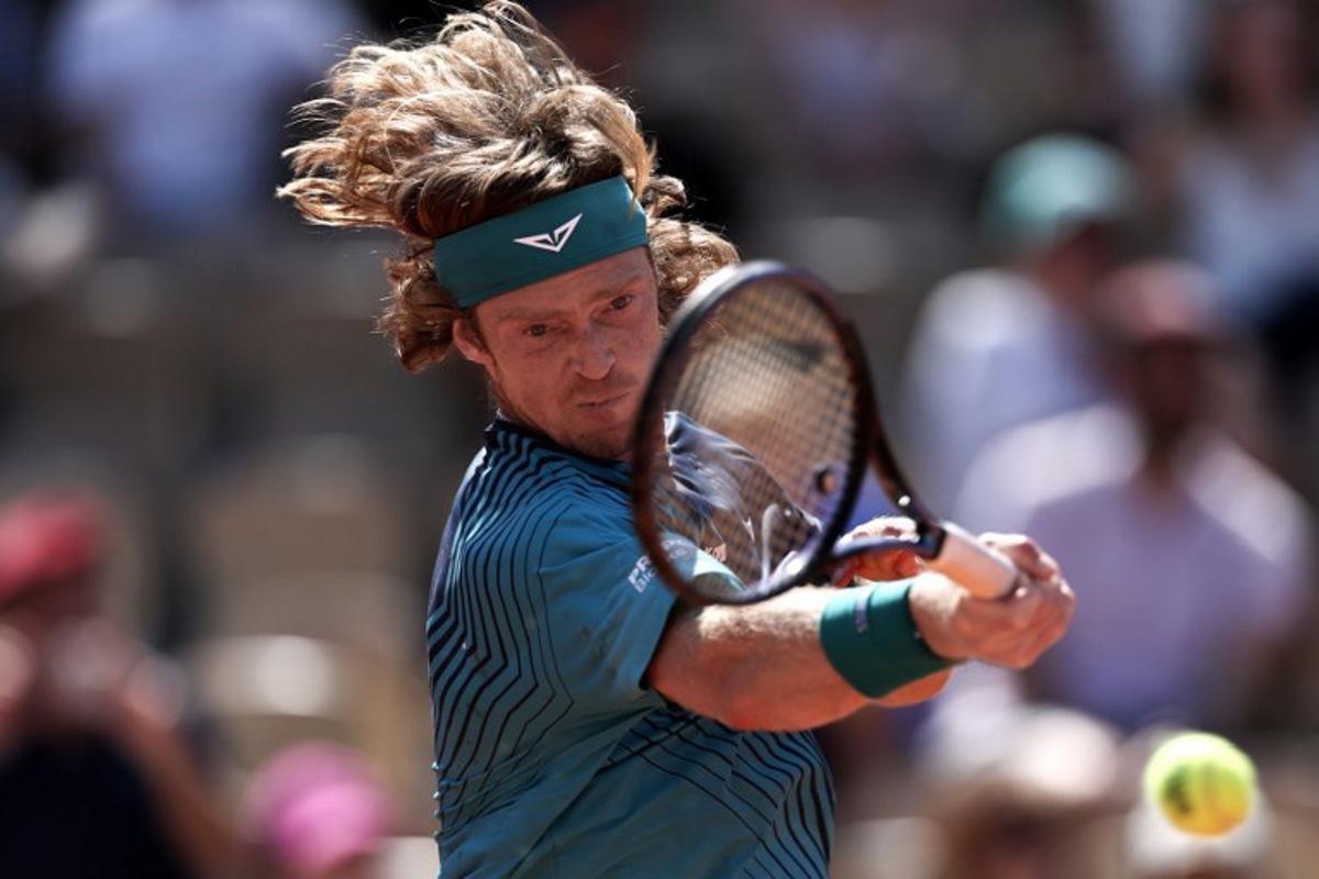 Andrey Rublev plays a forehand return to Argentina's Camilo Ugo Carabelli during their men's singles match on day 4 of the French Open tennis tournament on Court Simonne-Mathieu at the Roland-Garros Complex in Paris on May 27, 2026. Anne-Christine POUJOULAT / AFP
